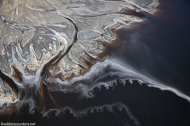 Evaporated sodium compound trails on the surface of Lake Natron beside lake shore, Tanzania, Canon 5D MK3, Canon 24-105mm f4 IS lens @47mm, handheld, 1/2,500 sec, f4, ISO 400, AV at 0