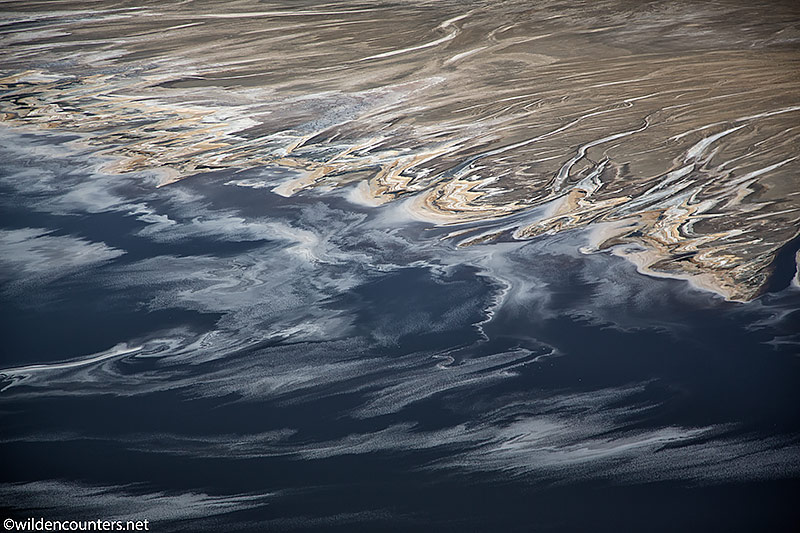 Aerial view of trails of evaporated sodium compounds lake surface, beside river delta, Lake Natron, Tanzania, Canon 1D MK4, Canon 24-105mm lens @96mm, handheld 1/5,000 sec, f4, ISO 400, AV at -1/3
